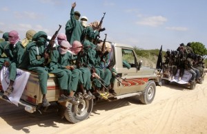 Militants of al Shabaab ride on pick-up trucks after displaying their weapons on the outskirts of Mogadishu